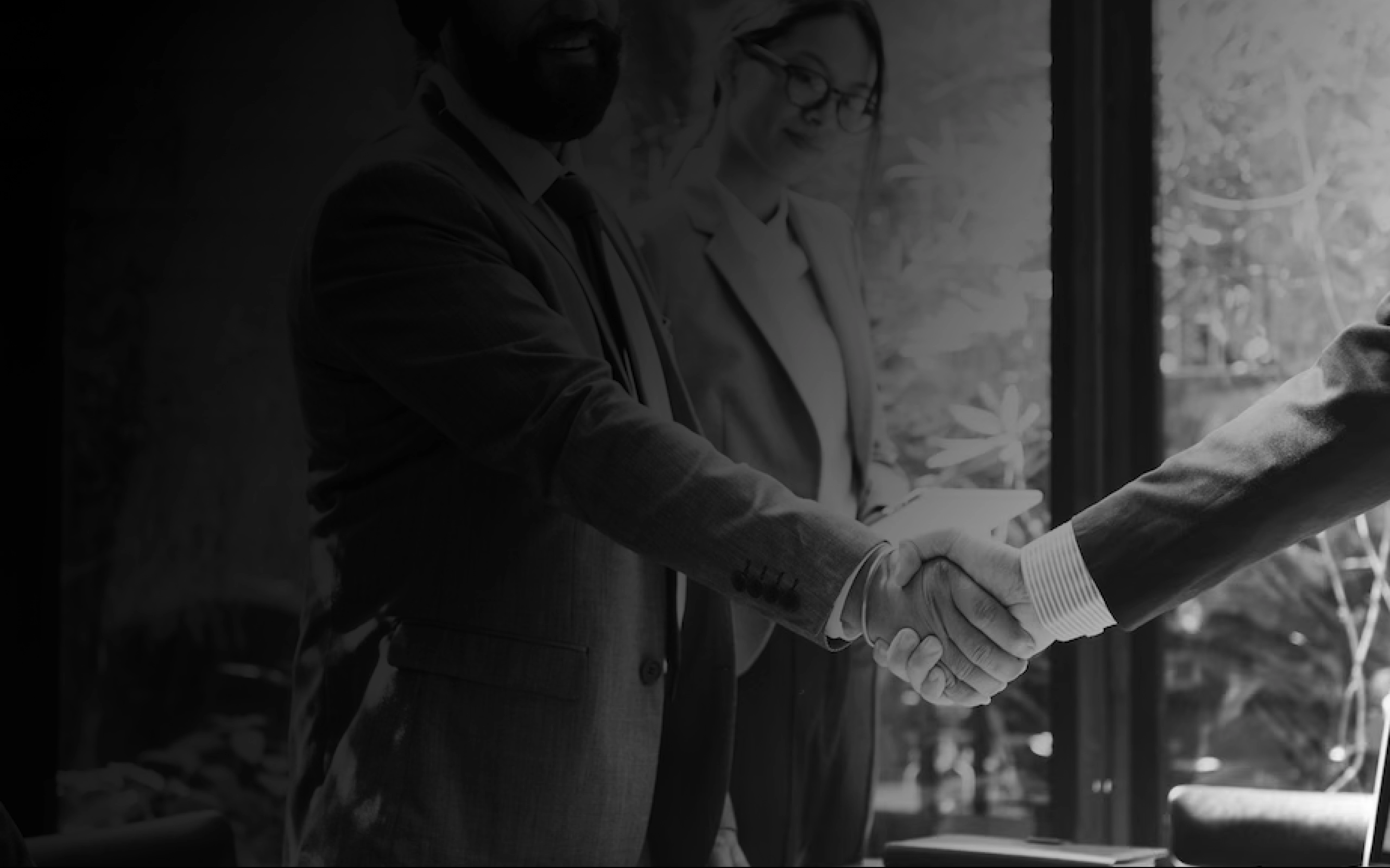 Business partnership handshake representing long-term consulting 